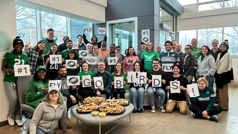 interius group shot with employees cheering for the Eagles to win the Super Bowl