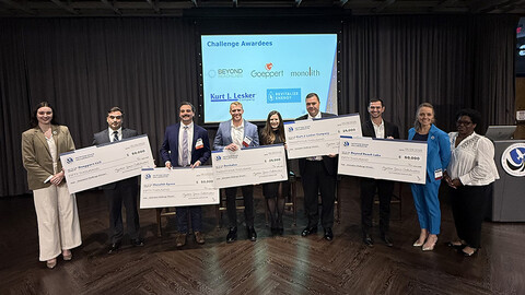 Winners holding their checks