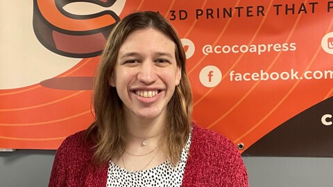 Cocoa Press banner with the 3D chocolate printer creator standing in front