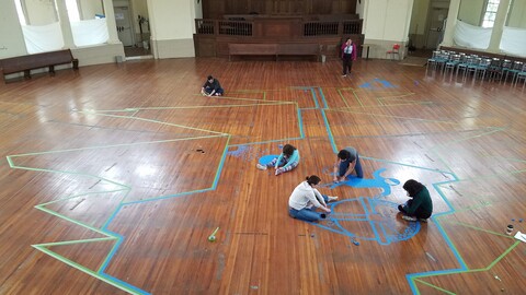 students creating a tape mural