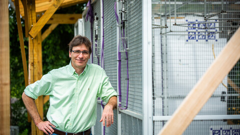 Biology professor Marc Schmidt outside the smart aviary on Pennovation Works campus