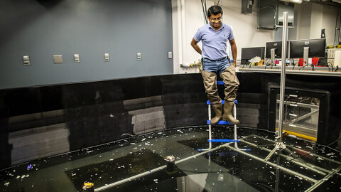 Penn Engineer testing an ocean simulating indoor pool