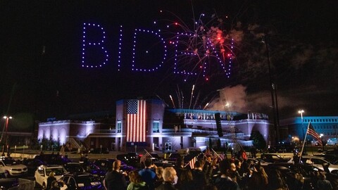 Drones in night sky spelling out Biden