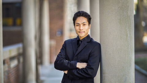 Photo of Michael Wong leaning against a column