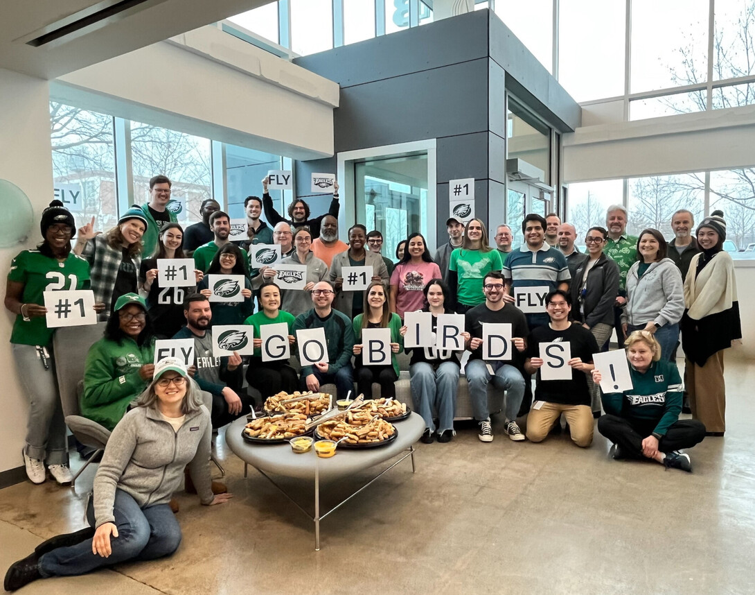 interius group shot with employees cheering for the Eagles to win the Super Bowl