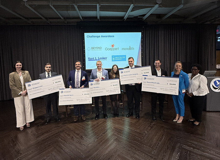 Winners holding their checks