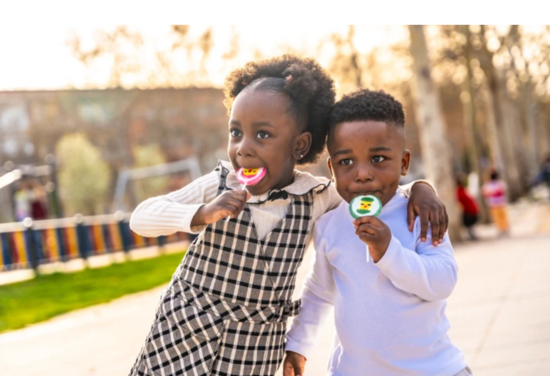 Two children eating lollipops