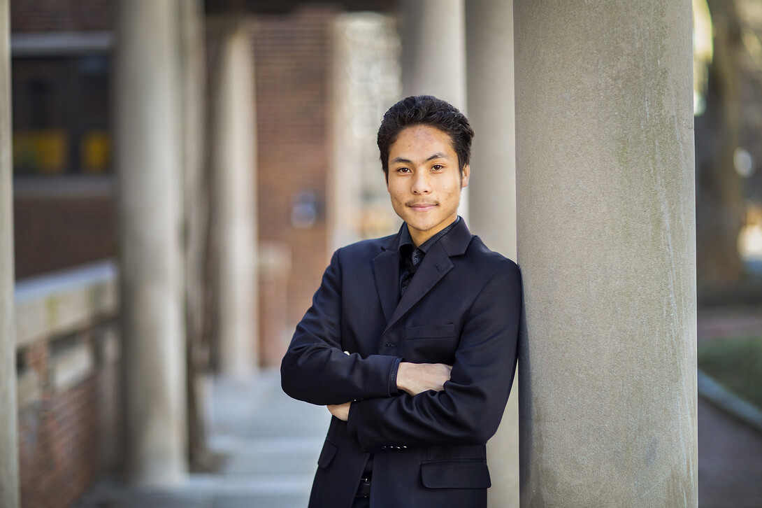 Photo of Michael Wong leaning against a column